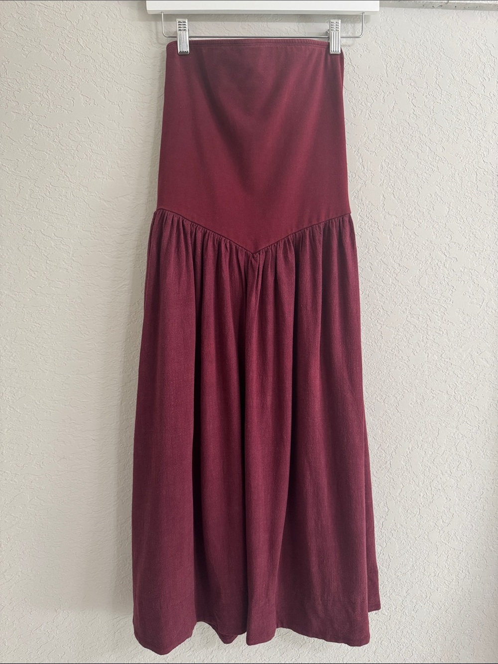 Women's strapless maroon midi dress.
